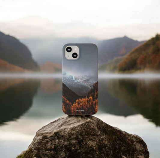  A renewable phone case printed with a picture of a body of water and trees.