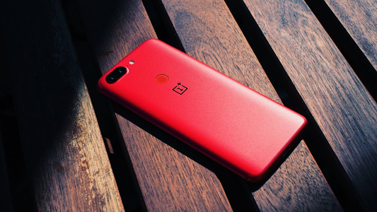 A red-colored phone case on wooden panels