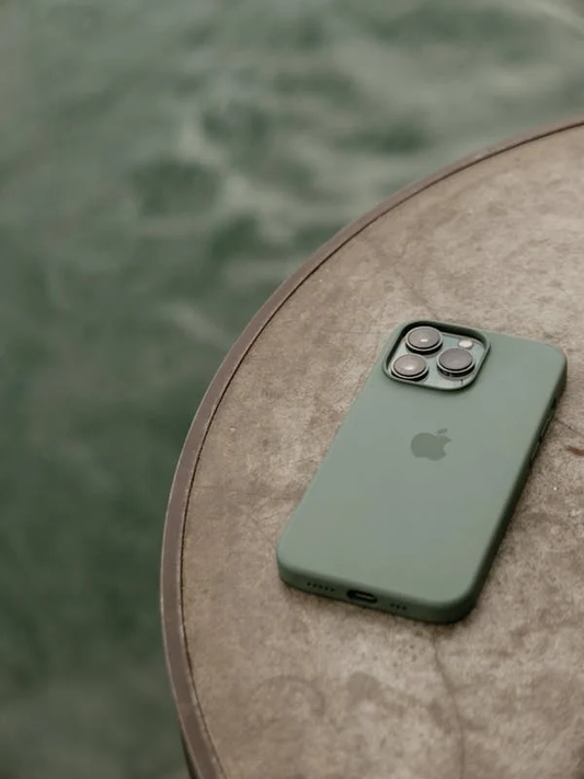 Phone with a green compostable phone case on a table